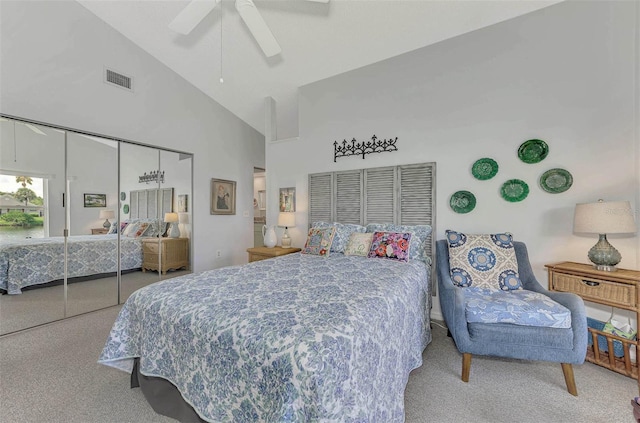 bedroom with high vaulted ceiling, a closet, ceiling fan, and carpet flooring