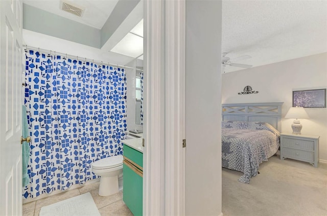 bathroom with vanity, a textured ceiling, ceiling fan, tile patterned flooring, and toilet