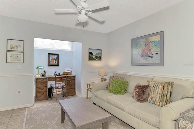 tiled living room with ceiling fan and a textured ceiling