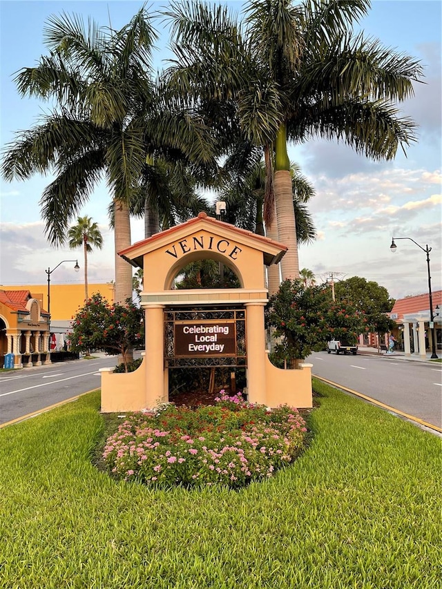 community / neighborhood sign featuring a lawn