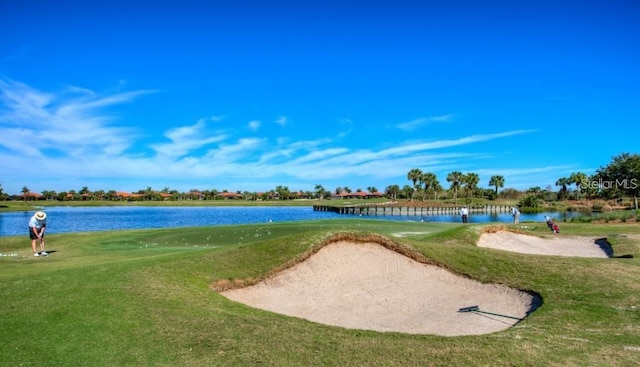 surrounding community featuring a water view and a lawn