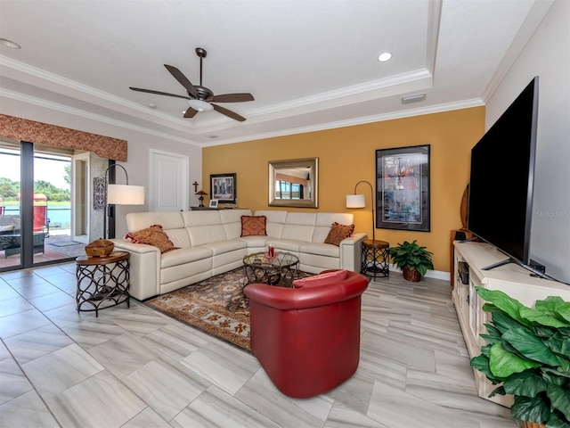 tiled living room featuring ceiling fan, a raised ceiling, and crown molding