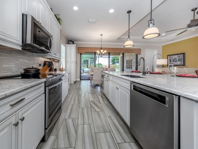 kitchen featuring sink, white cabinetry, backsplash, and stainless steel appliances