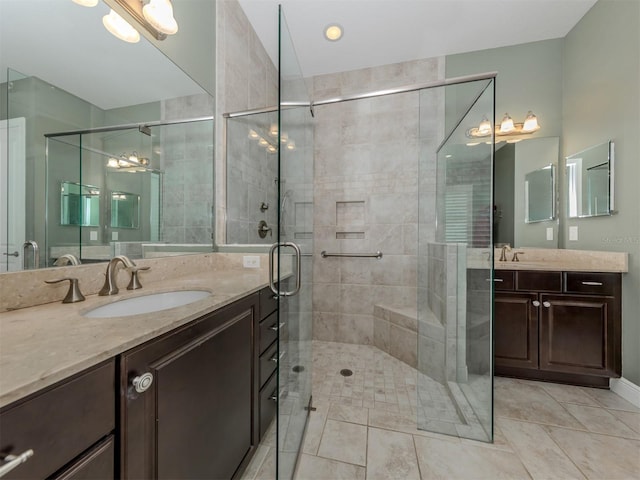 bathroom featuring a shower with door, vanity, and tile patterned floors