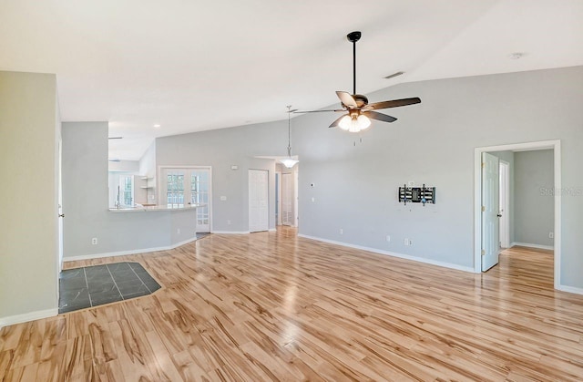 unfurnished living room featuring light hardwood / wood-style flooring, ceiling fan, and high vaulted ceiling