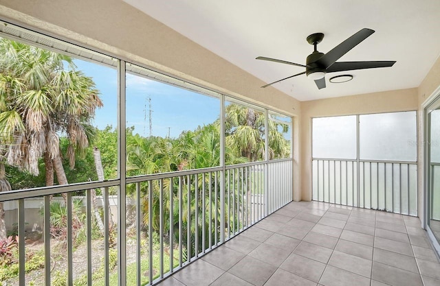 unfurnished sunroom featuring ceiling fan and a wealth of natural light