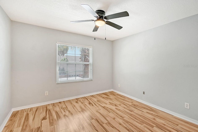 spare room with ceiling fan, light hardwood / wood-style floors, and a textured ceiling