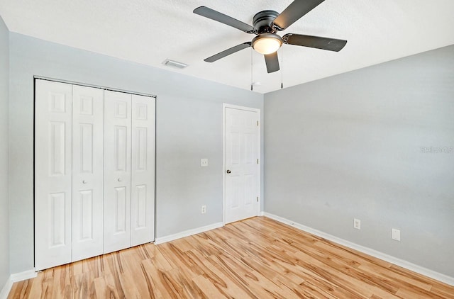 unfurnished bedroom with a closet, ceiling fan, and light hardwood / wood-style floors