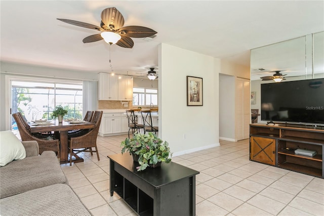 tiled living room with ceiling fan