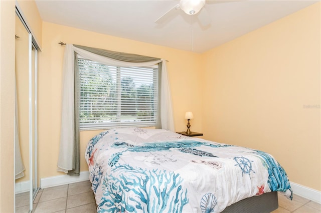 bedroom with a closet, ceiling fan, and light tile patterned floors