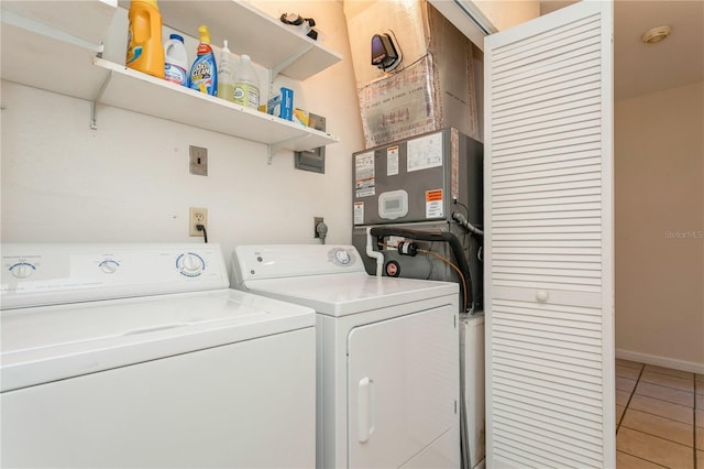 laundry area with washing machine and clothes dryer and tile patterned floors