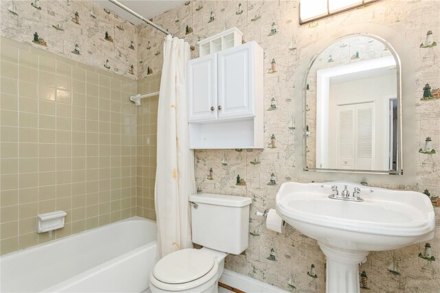 18069 Ohara Dr, Port Charlotte, FL 33948 - bathroom with shower / bath combo, toilet, baseboards, and wallpapered walls