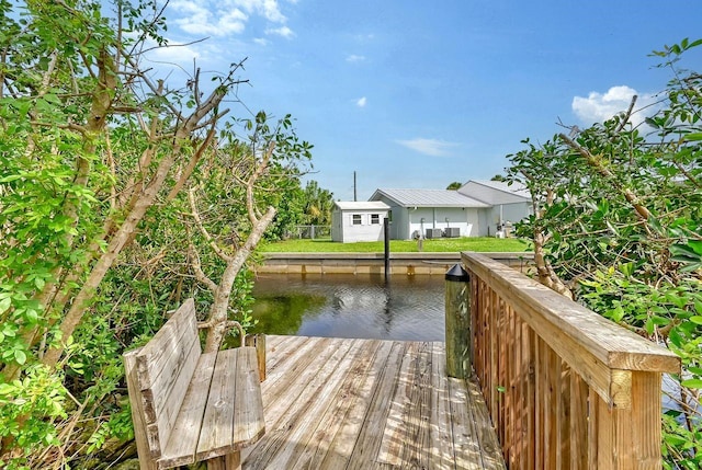 view of dock featuring a lawn and a water view