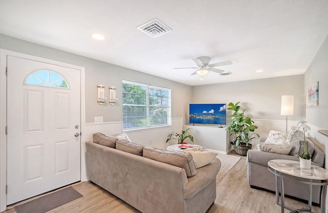 living room with light wood-type flooring and ceiling fan