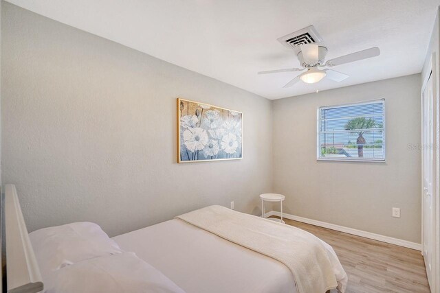 bedroom featuring hardwood / wood-style floors and ceiling fan