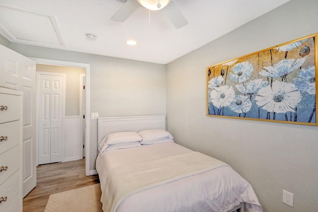 bedroom featuring ceiling fan, a closet, and light hardwood / wood-style floors