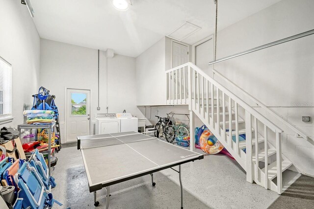 game room with a towering ceiling and independent washer and dryer