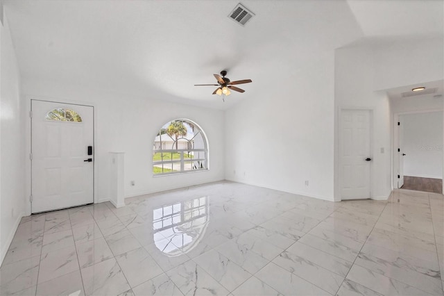 foyer entrance featuring ceiling fan, lofted ceiling, and light tile patterned flooring