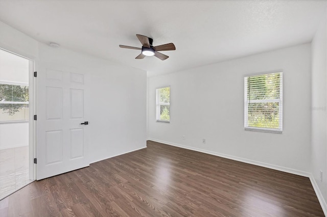 unfurnished room with ceiling fan, dark hardwood / wood-style floors, and plenty of natural light