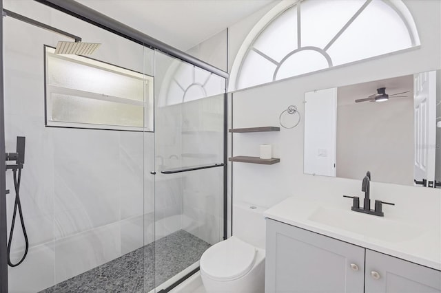 bathroom with a wealth of natural light, toilet, ceiling fan, and vanity