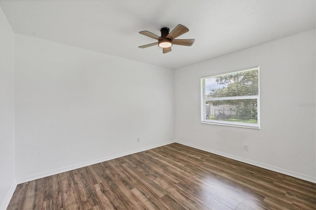 empty room with ceiling fan and dark wood-type flooring