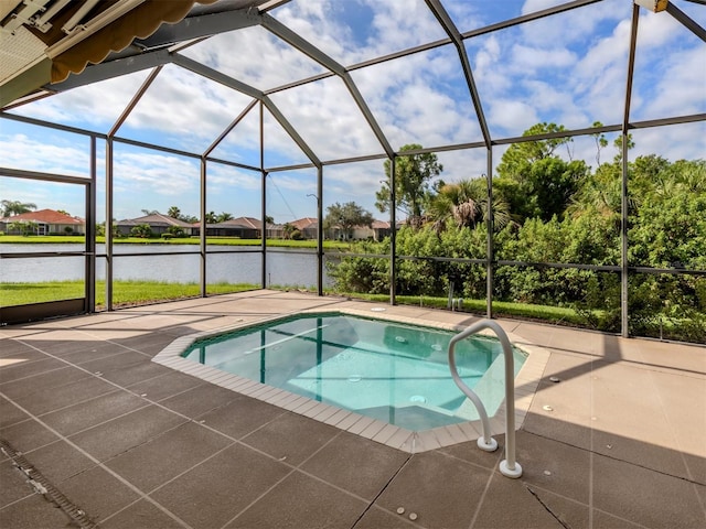 view of pool featuring a patio area, glass enclosure, and a water view