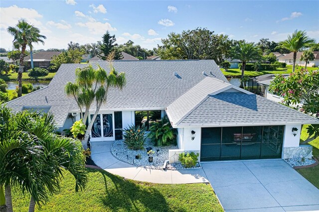 view of front of home featuring a front lawn and a garage