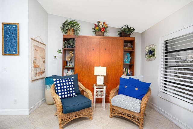 sitting room with tile patterned flooring and baseboards