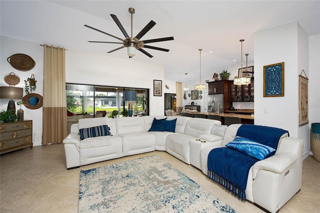 living room with ceiling fan with notable chandelier