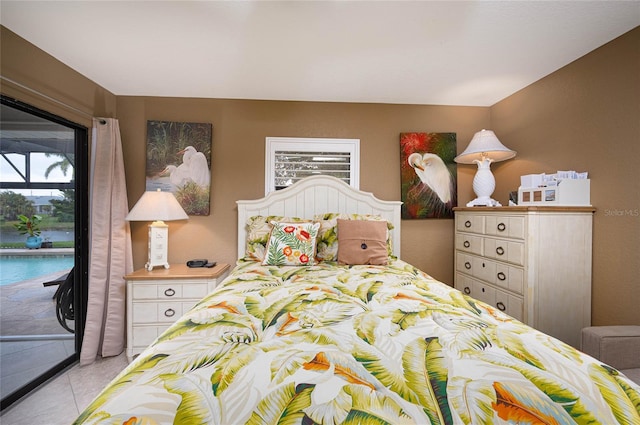 bedroom with access to outside and light tile patterned floors