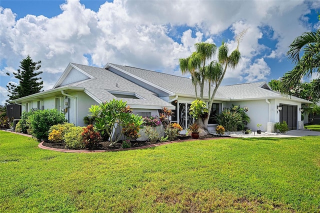 ranch-style house featuring stucco siding, a shingled roof, a garage, driveway, and a front lawn