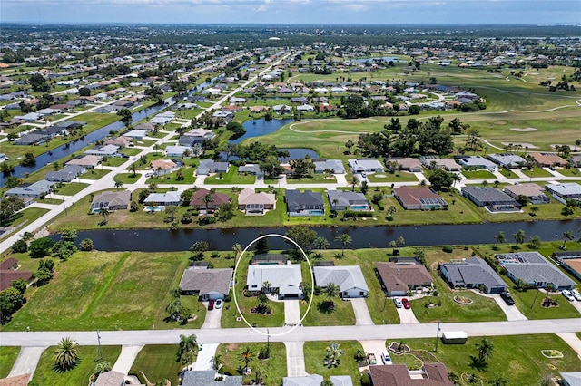 birds eye view of property featuring a residential view, a water view, and golf course view