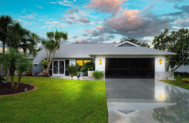 single story home featuring roof with shingles, a yard, stucco siding, concrete driveway, and a garage