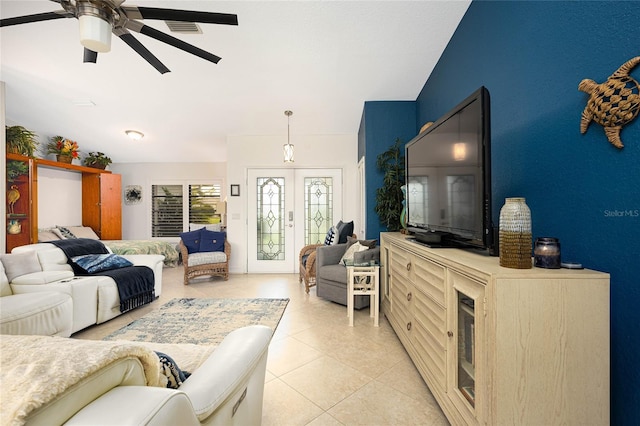 living room with visible vents, light tile patterned flooring, ceiling fan, and french doors