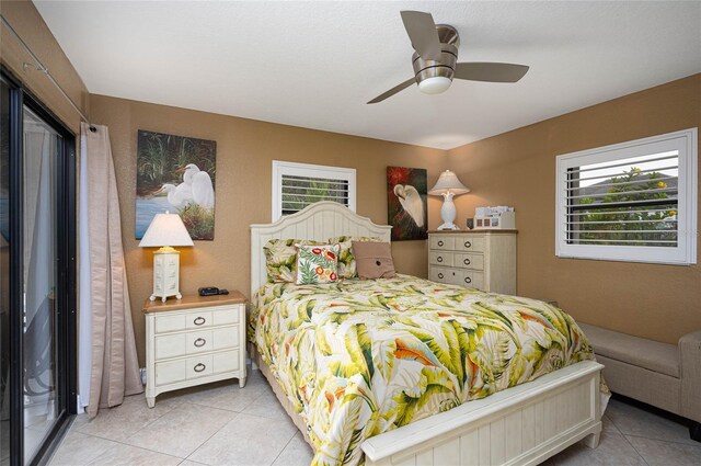 bedroom with ceiling fan and light tile patterned flooring