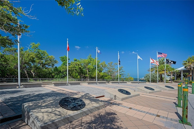 surrounding community featuring an outdoor fire pit and fence