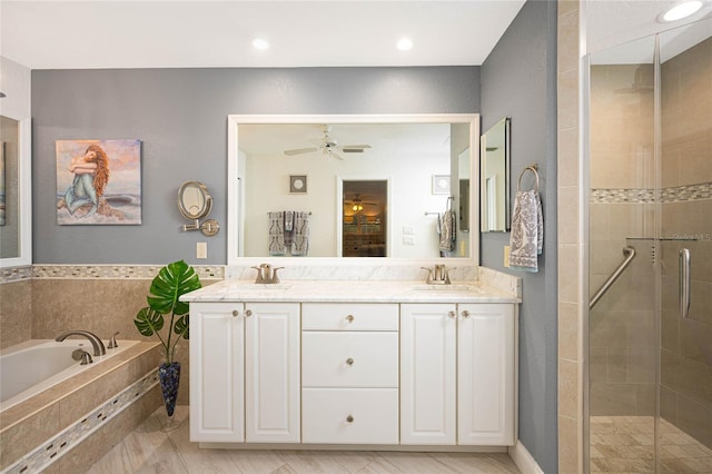 full bathroom featuring double vanity, a sink, a shower stall, and a bath