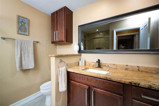 full bath featuring a stall shower, baseboards, toilet, tile patterned floors, and vanity