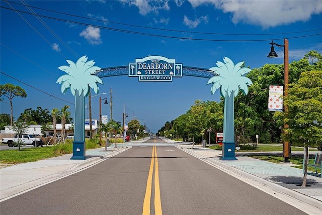 view of road with sidewalks, curbs, and street lights