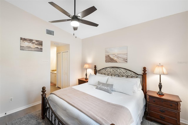 bedroom with hardwood / wood-style floors, lofted ceiling, ensuite bath, a closet, and ceiling fan