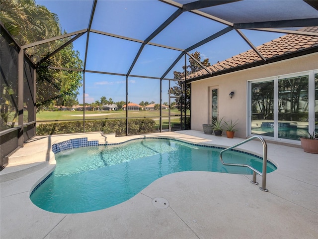 view of pool featuring pool water feature, glass enclosure, and a patio