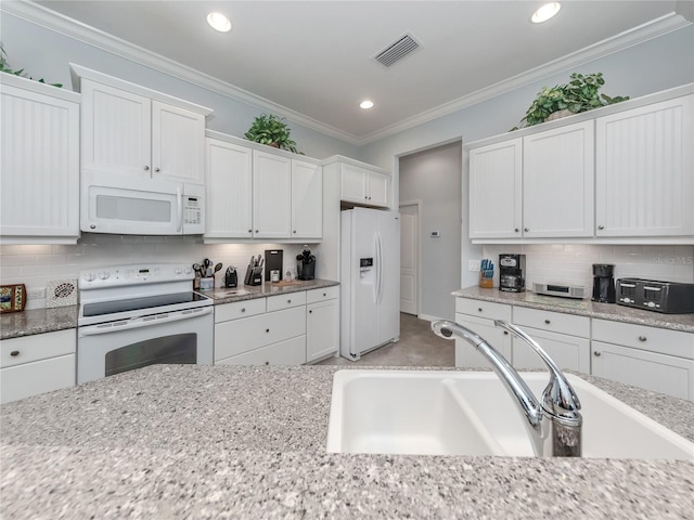 kitchen with tasteful backsplash, sink, white appliances, ornamental molding, and white cabinets