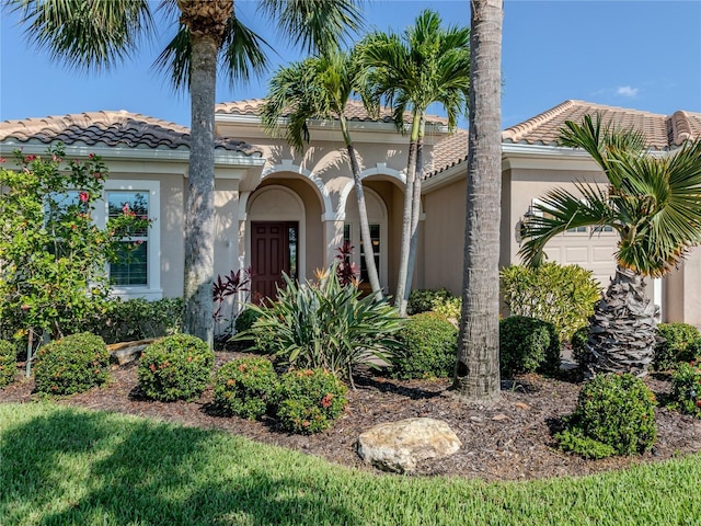 mediterranean / spanish-style home with a garage