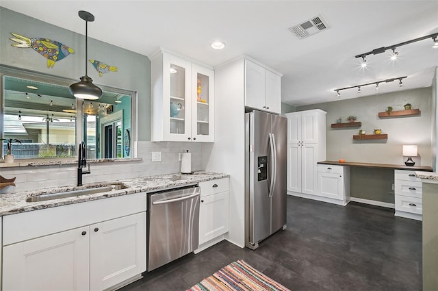 kitchen featuring backsplash, sink, light stone counters, stainless steel appliances, and white cabinets