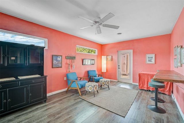 sitting room with hardwood / wood-style flooring and ceiling fan