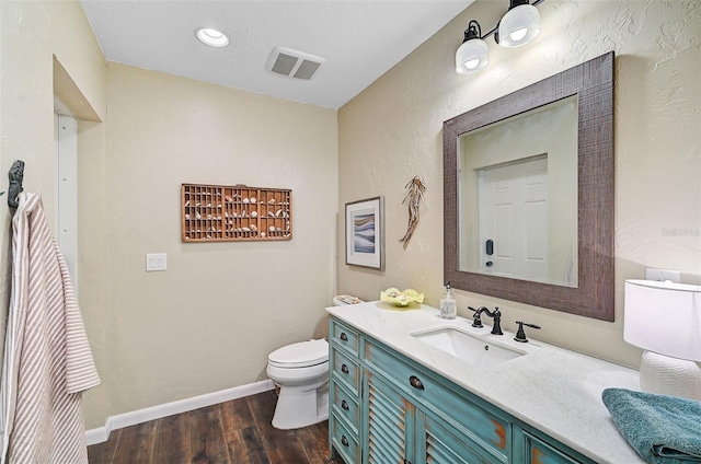 bathroom featuring hardwood / wood-style flooring, vanity, and toilet