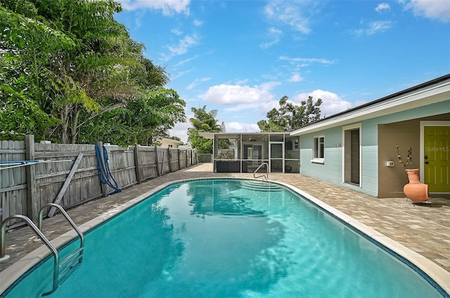 view of pool featuring a patio and a sunroom