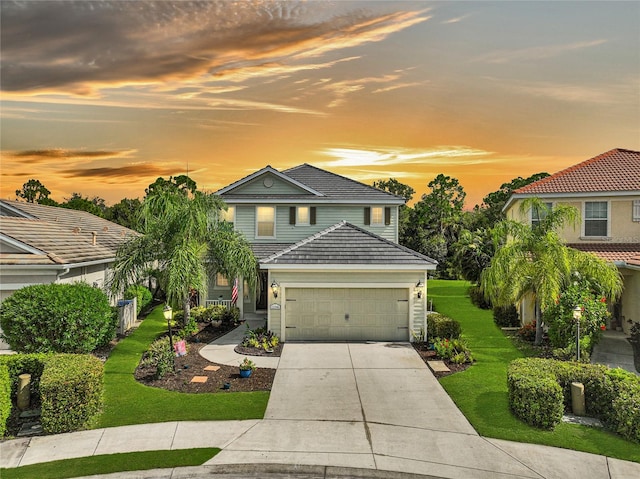 view of front of property with a lawn and a garage