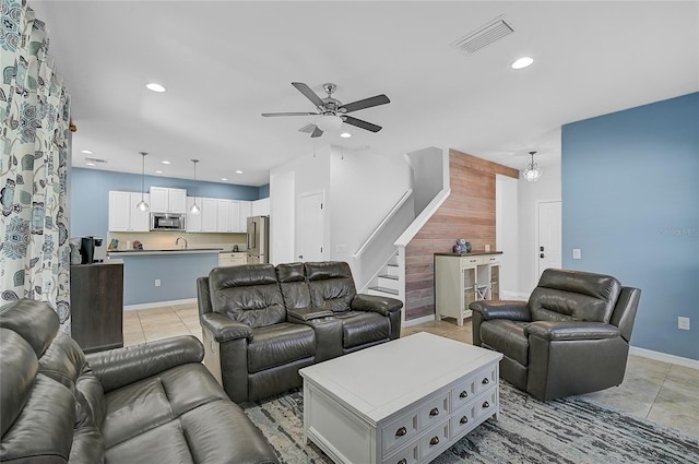 tiled living room featuring ceiling fan