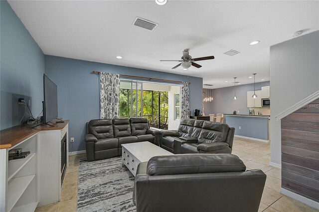 tiled living room featuring ceiling fan